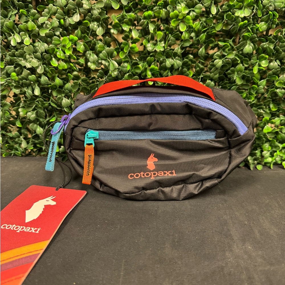 cotopaxi Black Waist Pack with Orange Handle and Purple/Blue Accents